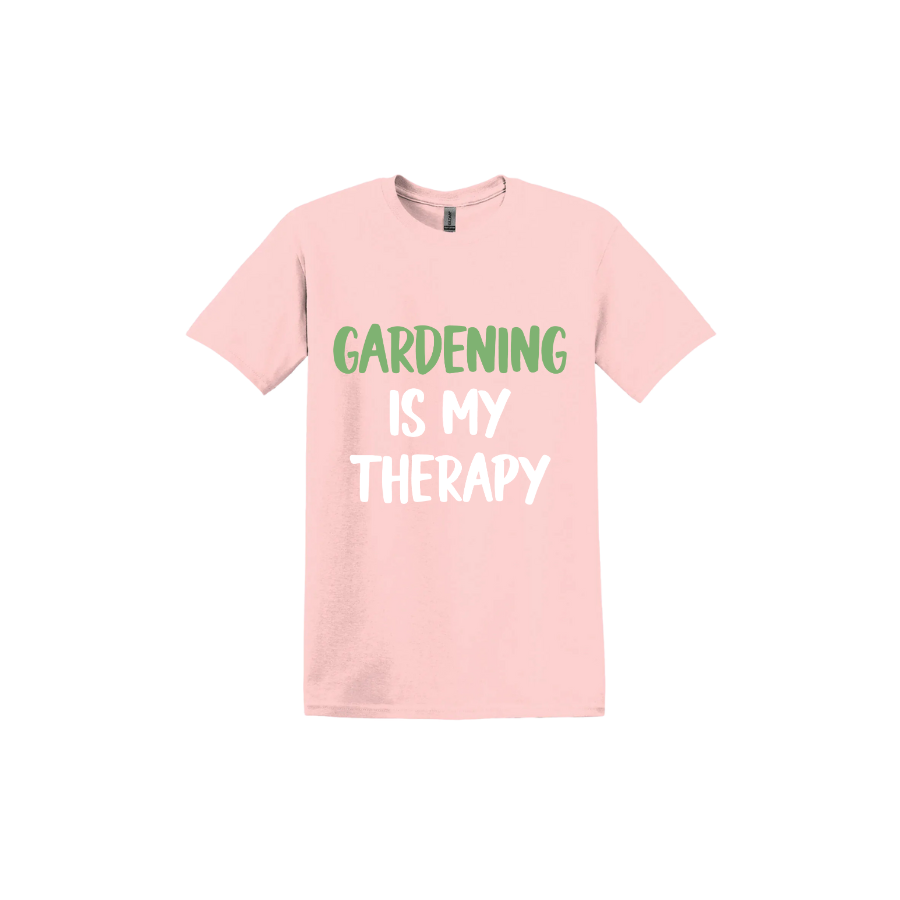 Light pink unisex tshirt with white and green text that reads 'Gardening Is My Therapy' in the center.