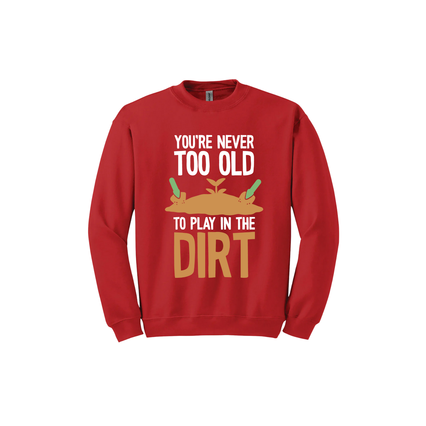 Red unisex sweatshirt with text that reads 'You're never too old to play in the dirt' along side graphics of a mound of dirt with two gardening trowels.