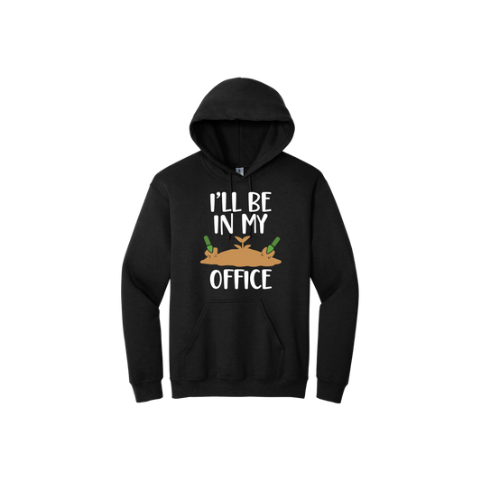 Black unisex hoodie with text reading 'I'll be in my office' alongside a graphic of dirt with two green shovels.