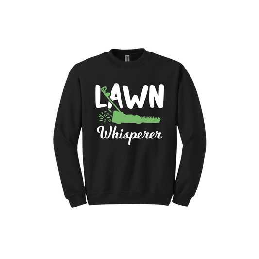 Black unisex sweatshirt with white text that reads 'Lawn Whisperer' alongside a graphic of a green lawnmower cutting grass.