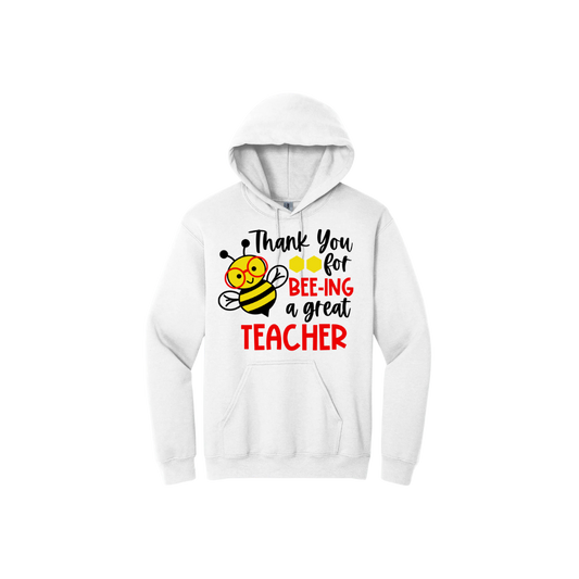 White unisex hoodie with text that reads 'Thank you for bee-ing a great teacher' alongside of graphics of honeycombs and a bee wearing red glasses.