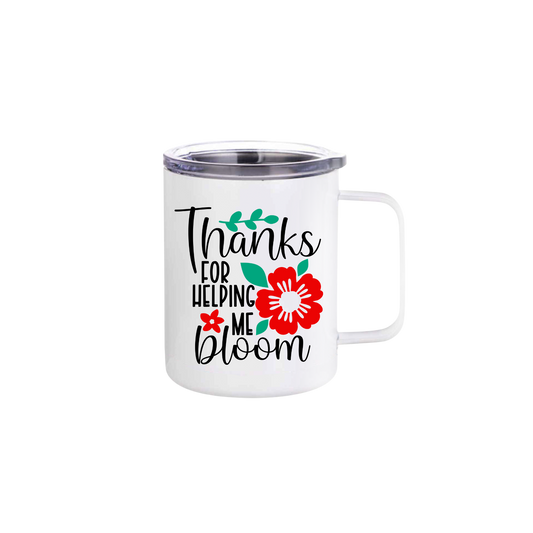 A white stainless steel mug featuring text that reads 'Thanks for helping me bloom' along with graphics of green leaves and red flowers.