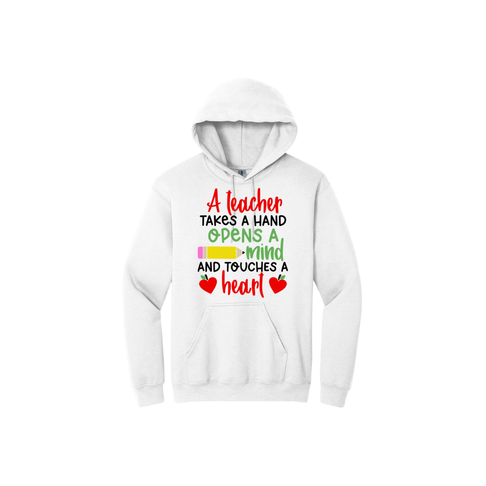 White hoodie with colorful text reading "A teacher takes a hand opens a mind and touches a heart". The design features a pencil and two apples in the shape of hearts.