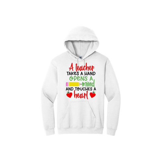 White hoodie with colorful text reading "A teacher takes a hand opens a mind and touches a heart". The design features a pencil and two apples in the shape of hearts.