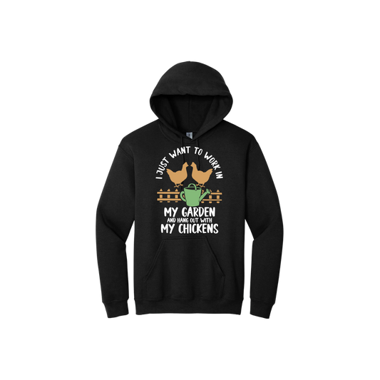 Black unisex hoodie with text that reads 'I just want to work in my garden and hangout with my chickens' with graphics of two chickens above a picket fence and a green watering can.
