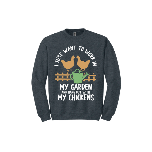 Dark heather unisex sweatshirt with text that reads 'I just want to work in my garden and hangout with my chickens' with graphics of two chickens above a picket fence and a green watering can.